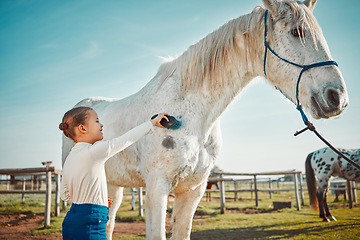 Image showing .Smile, brush and horse with girl on countryside for riding, equestrian and affectionate. Pet, pasture and champion stallion with child jockey and animal on nature ranch for relax, travel or weekend.