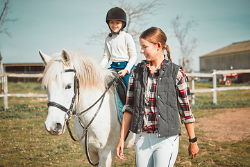 Image showing .Woman, child on horse and happy ranch lifestyle and animal walking on field with girl, mother and smile. Countryside, rural nature and farm animals, mom teaching and helping kid to ride pony in USA.