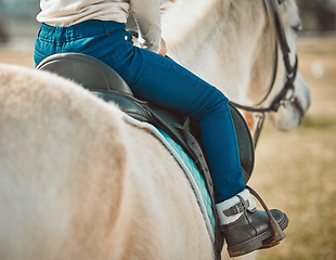 Image showing .Sports, riding and shoes of girl on horse in countryside for hobby, equestrian and learning. Cowgirl, summer and pasture with child jockey and pet on animal ranch for summer, vacation and adventure.