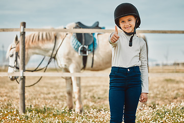 Image showing .Happy, thumbs up and horse with portrait of girl in countryside for approval, equestrian and adventure. Winner, goals and smile with child jockey on animal ranch for pet care, pasture and leisure.