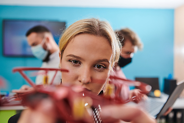 Image showing A group of students working together in a laboratory, dedicated to exploring the aerodynamic capabilities of a drone