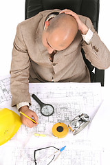 Image showing Businessman thinking with architectural plans