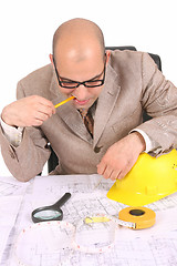 Image showing Businessman thinking with architectural plans