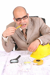 Image showing Businessman thinking with architectural plans