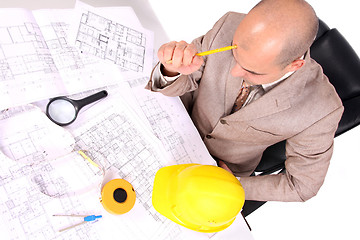 Image showing Businessman thinking with architectural plans