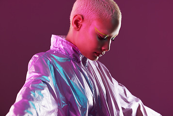 Image showing Woman, holographic fashion and face glow for hologram trend isolated on a studio background. Futuristic, vaporwave and art color jacket on cyberpunk model for retro cosmetics and makeup shine on skin