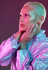 Image showing Beauty, cyberpunk and fashion black woman with unique style, makeup and hairstyle isolated in a studio neon background. Creative, artistic and bright and colorful female is trendy and stylish