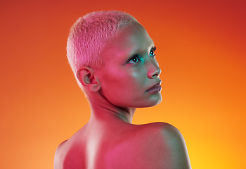 Image showing Art, neon beauty and woman with face makeup and lights in creative advertising on orange background. Cyberpunk, product placement and model isolated for skincare and futuristic mockup space in studio