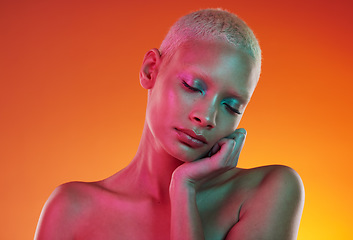 Image showing Skincare, beauty and neon cosmetics, woman with face makeup and light in creative advertising on orange background. Cyberpunk, product placement and model isolated in future mockup space in studio.