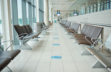 Image showing Empty lounge space in airport with chair, waiting room and global travel of covid regulations. Immigration lobby, seat or building interior design for transportation, furniture and clean backgrounds