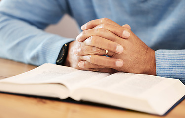 Image showing Praying, hands closeup and bible religion, faith and god knowledge, studying or research. Prayer, hope and christian person with holy book for learning, analysis and spiritual education or scripture