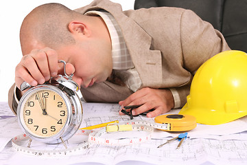 Image showing A businessman sleepy with architectural plans