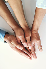 Image showing Hands together, business people and community of company team with work trust and goals. Teamwork, commitment and solidarity of office connect with white background showing staff collaboration