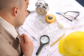 Image showing A businessman sleepy with architectural plans