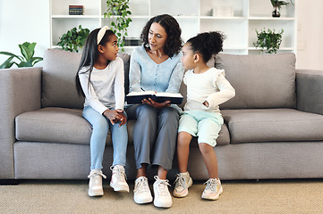 Image showing Senior family reading books to children, teaching and learning bible story, questions and education in living room. Grandmother and kids on sofa with storytelling or holy religion, knowledge and help