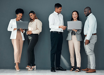 Image showing Business people, group and laptop with coach for learning, proposal and teamwork by wall background together. Young executive team, diversity and mentor with men, women and computer for web design