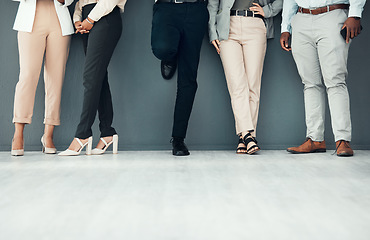 Image showing Legs, waiting room and group of people for interview, recruitment or job opportunity on wall background. Shoes, candidates and men with women on mockup for work hiring, process and company startup