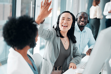 Image showing Success, teamwork and high five with asian woman in call center for customer support, contact us and communication. Winner, goals and target with people in office for deal, consulting and help desk