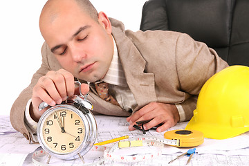 Image showing A businessman sleepy with architectural plans