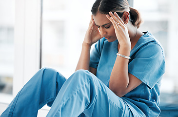 Image showing Burnout, stress and medical with nurse on floor of hospital for sad, mental health and headache. Anxiety, depression and frustrated with tired woman in clinic for healthcare, medicine and nursing