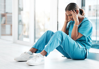 Image showing Depression, headache and medical with nurse on floor of hospital for sad, mental health and burnout. Anxiety, stress and frustrated with tired woman in clinic for healthcare, medicine and nursing