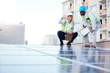 Image showing Solar energy, sustainability and engineer team on a rooftop to repair, program or install renewable power in a city. Sustainable, man and teamwork by technician for eco friendly electricity