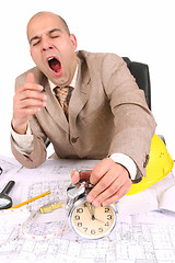 Image showing A businessman sleepy with architectural plans