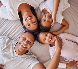 Image showing Portrait, family and kids on a bed with their parents, lying together in the morning at home overhead. Love, relax or bedroom with a mother, father and children bonding over the weekend in a circle