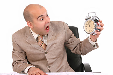 Image showing businessman looking at clock alarm