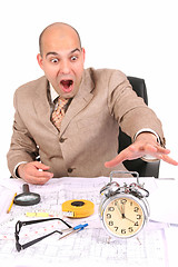 Image showing businessman looking at clock alarm