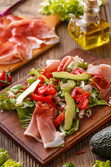 Image showing Green salad with thin slices of ham