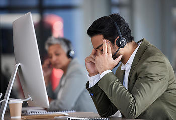 Image showing Stress, customer service and a man consultant working in a call center while suffering from a headache. Burnout, telemarketing and a male consulting while feeling frustrated or tired of support
