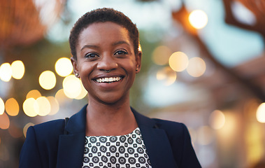 Image showing Smile, confident black woman and portrait in a city with bokeh, lights and blurred background space. Face, traveller and happy African American person in town for fun, break or trip on the weekend