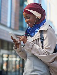 Image showing Black woman, phone and smile listening to music in the city for communication, social media or chat. African American and independent girl typing on smartphone with 5G connection, app and earphones