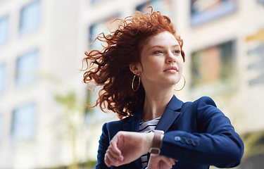 Image showing Woman in city, checking time and watch on wrist on morning commute to work or appointment. Street, schedule and businesswoman looking at smartwatch on urban sidewalk before job interview or meeting.