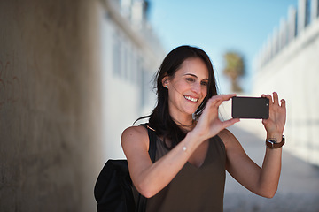 Image showing Travel, selfie and woman in a city, happy and smile while sightseeing, explore and adventure. Social media, profile picture and influencer blog post by girl in town live streaming to online followers