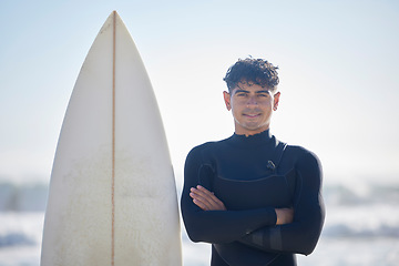 Image showing Surfing, portrait and surfer man with blue sky outdoor for water sports, training and exercise. Surfboard, morning workout and sea with summer sun and young person ready for waves sport at the ocean