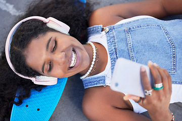 Image showing Top view, music headphones and black woman with phone for streaming podcast and radio. City technology, cellphone and happy female laughing with 5g smartphone for social media or internet browsing