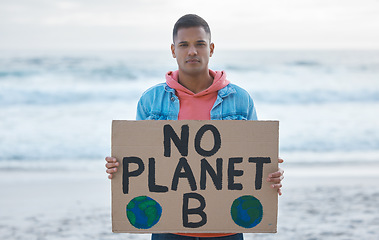 Image showing Save earth, sign and man protest at beach pollution, environment and green, eco planet. Ocean, sea and portrait of person with nature globe poster for awareness, global warming and climate change