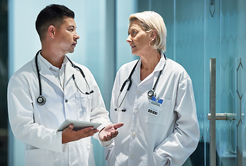 Image showing Medical, team and doctors talking planning a surgery with a tablet in a modern hospital in discussion or research together with mentor. Man, woman and healthcare professionals brainstorming at clinic