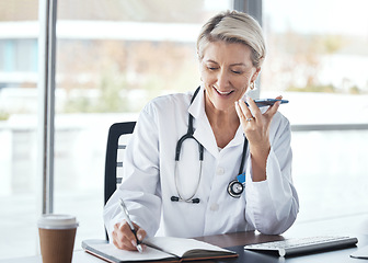 Image showing Woman, doctor and speaker phone, call and schedule appointment with health, writing notes and confirm consultation. Communication, tech and healthcare, calendar and senior medical employee at clinic