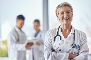 Image showing Healthcare, doctor and portrait of senior woman in hospital for wellness, medical care and support. Leadership, clinic and female health worker smile with team for insurance, trust and consultation