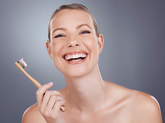Image showing Bamboo toothbrush, happy portrait and woman for dental wellness, healthy cleaning and face cosmetics. Female teeth, eco wooden brush and toothpaste for mouth smile, mature model and studio background