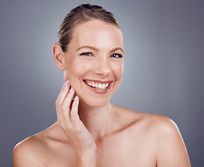 Image showing Beauty, face and woman in portrait with hand touching facial, dermatology and skincare on studio background. Cosmetic care, happy model and healthy skin with smile, natural cosmetics and wellness