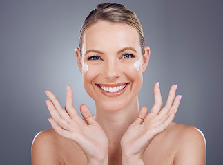 Image showing Skincare, facial cream and portrait of woman on gray background for wellness, cosmetics and treatment. Beauty, dermatology and happy girl smile with lotion, face moisturizer and anti aging products