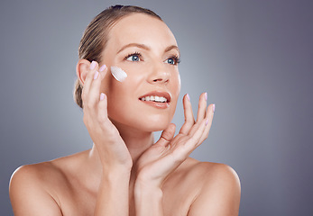 Image showing Skincare, cream and face of woman for beauty on gray background for wellness, cosmetics and facial treatment. Luxury spa, dermatology and happy girl with lotion, moisturizer and anti aging products