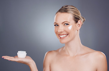 Image showing Cream, skincare mockup and portrait of woman on gray background for wellness, cosmetics and facial care. Beauty marketing, dermatology and girl with lotion, creme and anti aging product placement