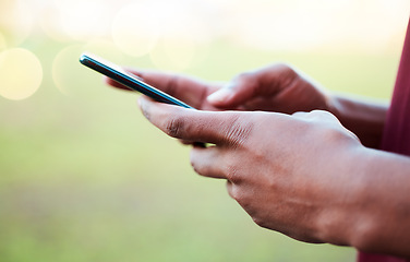 Image showing Hands, phone and communication on mockup for social media, texting or chatting in the outdoors. Hand of person typing on smartphone with 5G connection, browsing or mobile app on blurred background