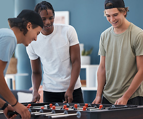 Image showing Student foosball, friends and men playing a game at students accommodation at university. Board, soccer and guys with happiness and fun competition together in a lounge playing on sports table