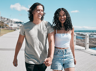 Image showing Portrait, holding hands and couple at the beach for travel, fun and walking against blue sky background. Happy, love and face of woman with man on vacation, relax and bond on a trip together in Miami